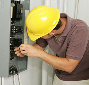 Electrician working on a fusebox